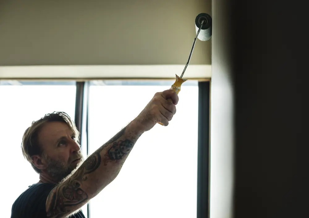Man With Tattoo Holding Roller Paint The Wall 2025 02 09 23 34 45 Utc