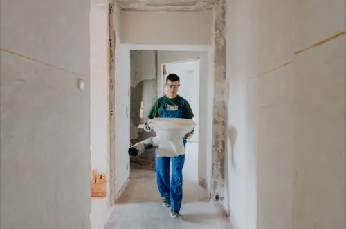 Man Carying Old Toilet Bowl 2024 09 19 01 04 40 Utc