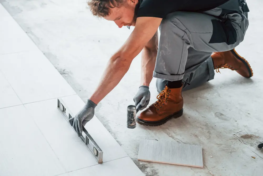 Man In Grey Uniform Installing Plate Indoors In Mo 2025 03 18 21 57 03 Utc
